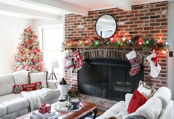 A cozy living room by the fireplace that's decorated with christmas decor