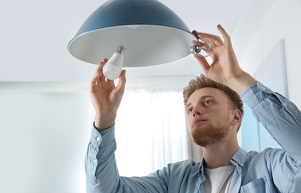 A man changing the light bulb